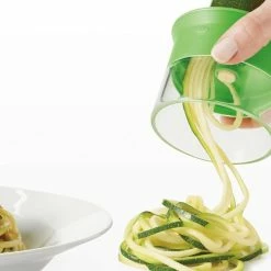 OXO Good Grips 3 Blade Hand Held Spiralizer- Makes 3 Different Noodles -Curious Shop hand held spiralizer with plate of spaghetti 11194200